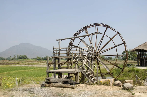Big wooden turbine baler water wheel at Thai Dam Cultural Villag