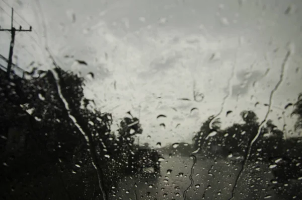 Raindrop on glass front of my car stop beside road — Stock Photo, Image