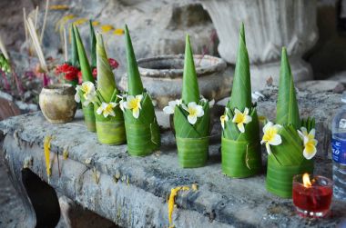 Sacrificial offering made from banana leaf and flower praying to clipart