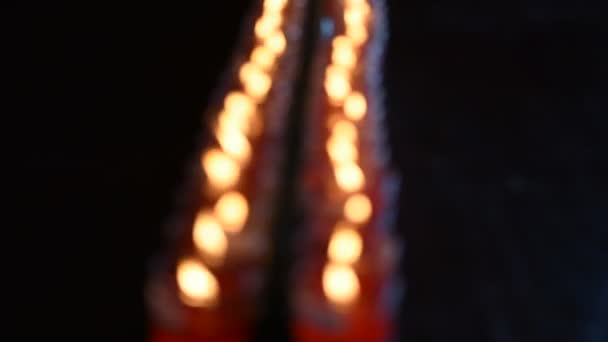 Colorful Bokeh of fire of candle for pray buddha — Stock Video