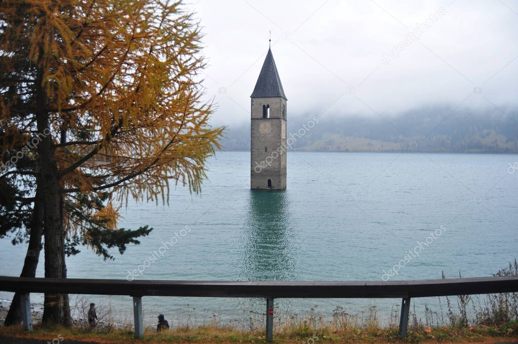 Submerged tower of reschensee church deep in Resias Lake of Bolz