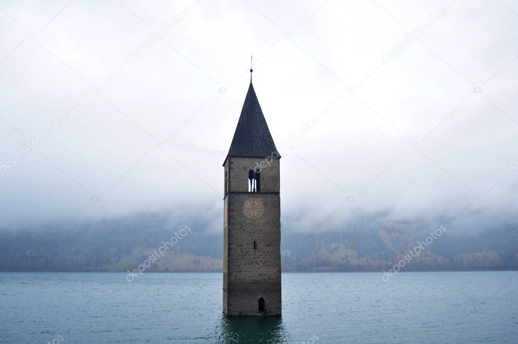 Submerged tower of reschensee church deep in Resias Lake of Bolz