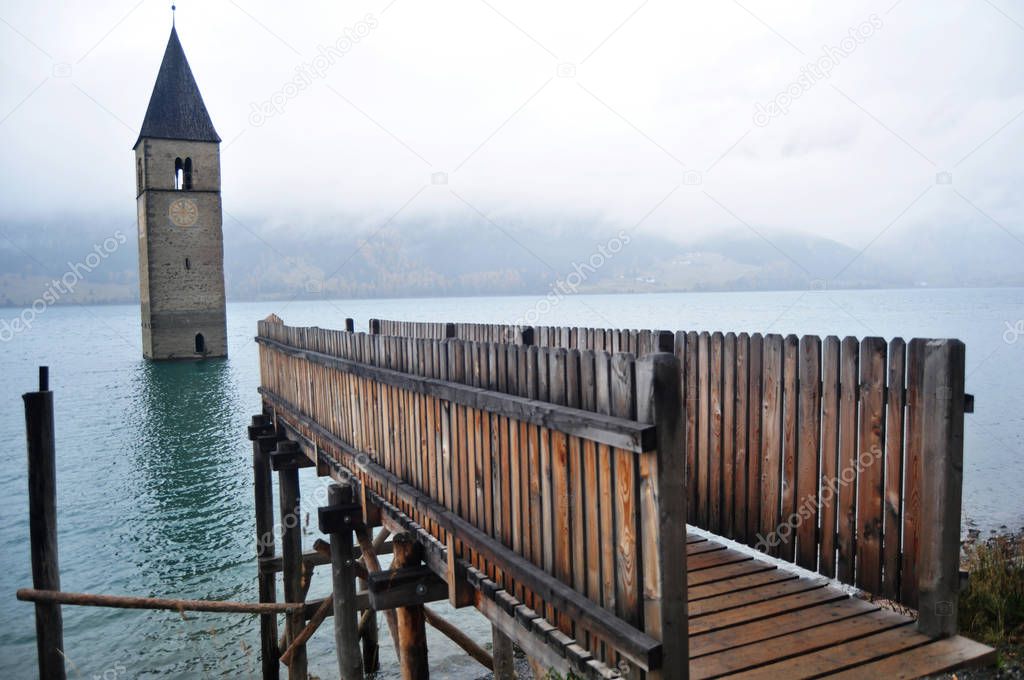 Submerged tower of reschensee church deep in Resias Lake of Bolz