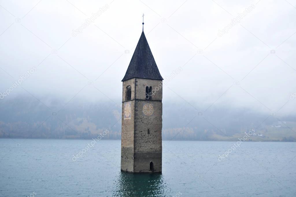 Submerged tower of reschensee church deep in Resias Lake of Bolz