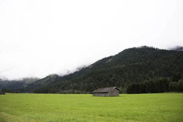 View landscape of mountain and grass field beside road at countr — Stock Photo, Image