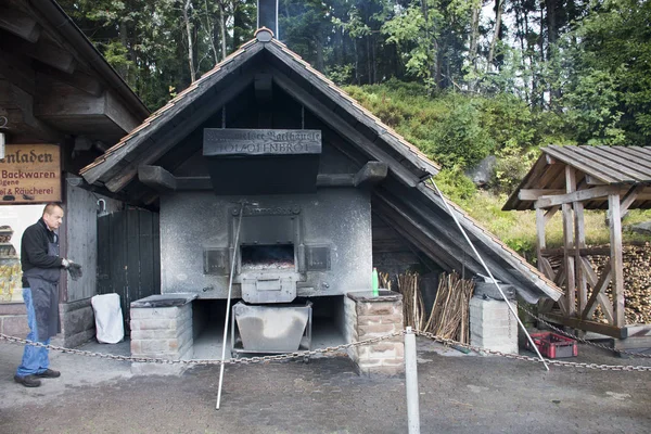German old men use firewood stove old style cooking bread at res