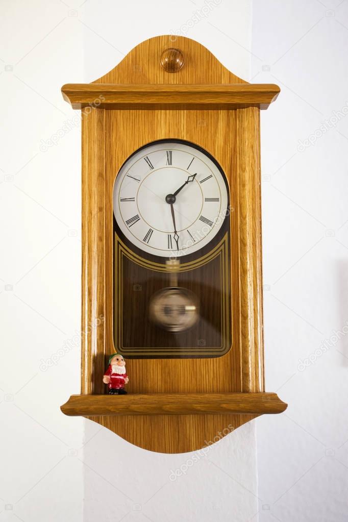 Wooden Classic clock germany style on wall in house
