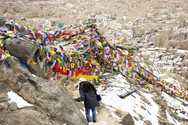 JAMMU KASHMIR, INDIA - MARCH 20 : Traveler thai women tied prayer and blessing flags on mount of Thiksey monastery and Namgyal Tsemo Gompa in Leh ladakh on March 20, 2019 in Jammu and Kashmir, India