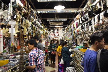 Thai people walking select and buying fabric material with acces
