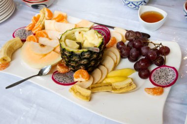 Yemek odasındaki büfede çeşitli meyveler gezginler ve misafirler için. Sabah vakti Tayland 'ın Ratchaburi kentindeki tatil otelinde içki seçip yiyin.