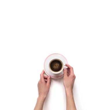 Female(woman) hand hold a white espresso cup with coffee isolate clipart