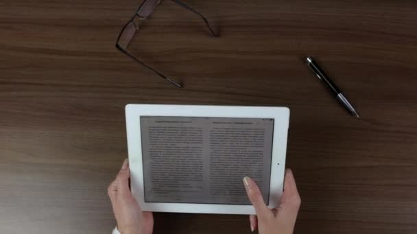 Tablet in female hands, woman reading. — Stock Video