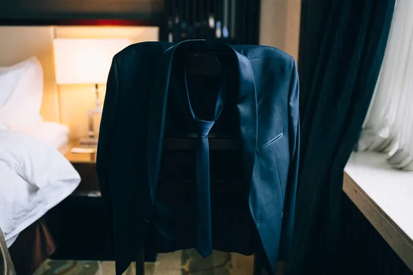 men\'s jacket on a hanger in the room