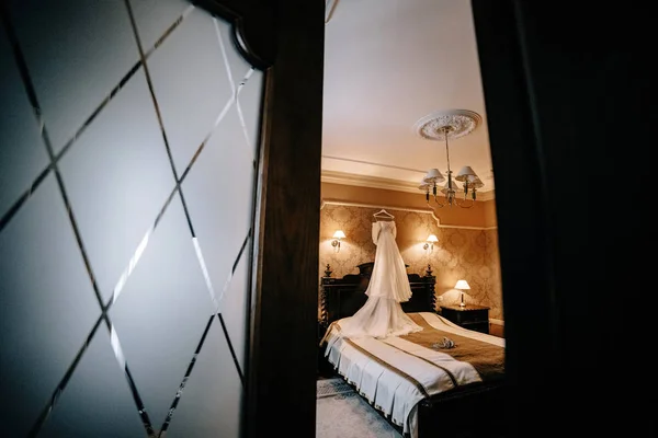 Wedding dress and shoes in the room