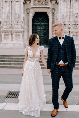 Gelin ve damat kilisenin önünde poz veriyor.