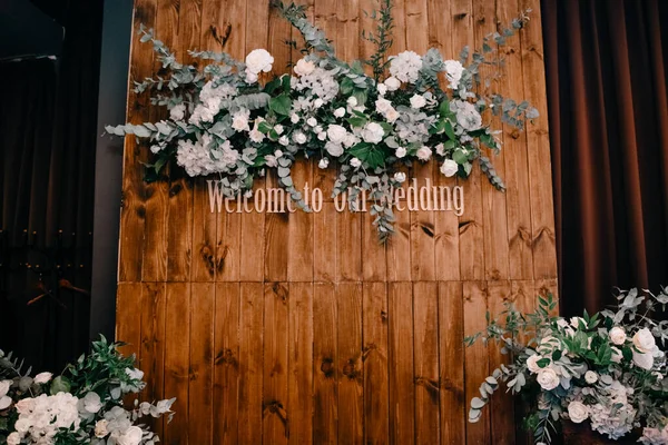welcome wedding signs on wooden board decorated by flowers