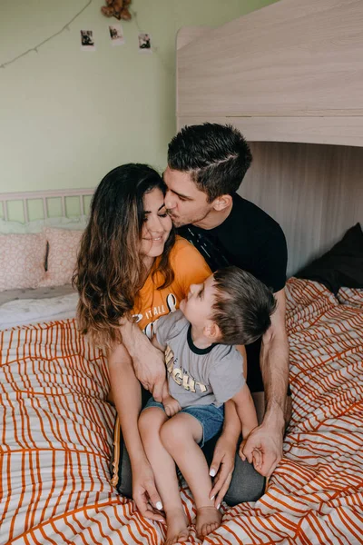 Happy family laying on bed in bedroom with happy and smile