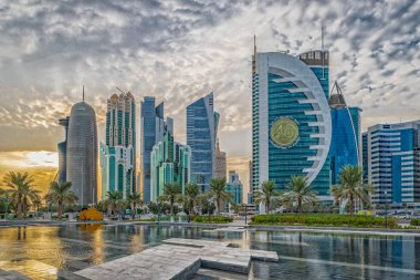 Doha, Qatar-November 18,2019: Doha, Qatar  Skyline daylight view from Sheraton park with reflection in the water and clouds in sky in background