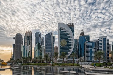 Doha, Qatar-November 18,2019: Doha, Qatar  Skyline daylight view from Sheraton park with reflection in the water and clouds in sky in background