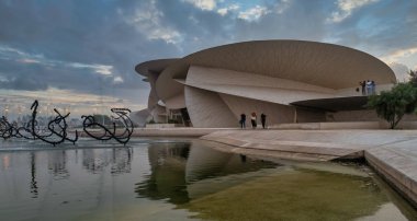 Doha, Qatar-October 25,2019 :National Museum of Qatar (Desert rose) exterior  daylight view with clouds in sky clipart
