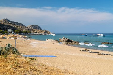 Yunan adasındaki Stegna plajı Kum, güneş gözlüğü ve boa ile Rodos