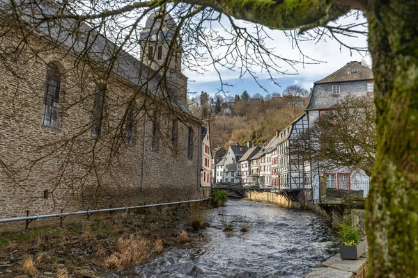 Half-timbered houses and church along the rur river in Monschau, Eifel