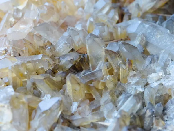 Background, smoky quartz crystals cluster close-up, in the rock. The most common mineral