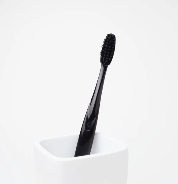 One Black Toothbrush Oral Care White Toothbrush Holder White Background — Stock Photo, Image