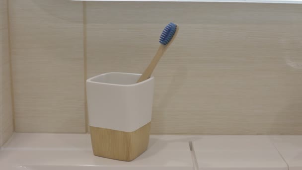 Man Takes Wooden Toothbrush Holder Hand Right Side Frame — Stock Video