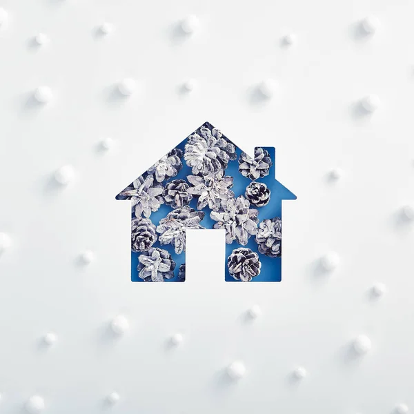 Silueta de casa hecha de cono de pino nevado con patrón de nieve abstracto — Foto de Stock