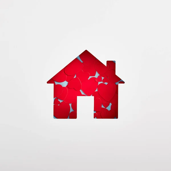 Home silhouette filled with red hearts on white background — Stock Photo, Image