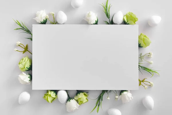 Herbs and spring flowers blank botanical frame on white background. Easter holiday decoration, rose stems and plant twigs with leaves close up. Rustic style empty border with floral decorations