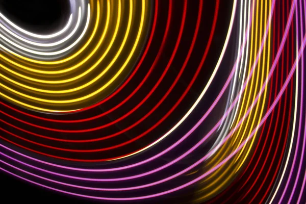 Yellow, red and pink light curve lines on a black background
