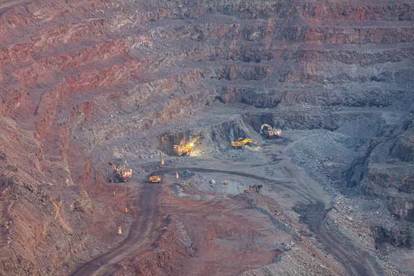 The process of mining iron ore in the quarry in the evening