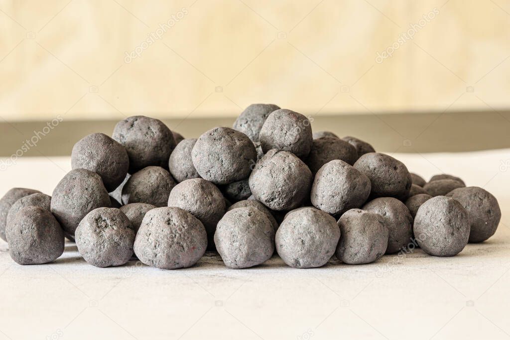 Iron ore pellets on a table on a light background