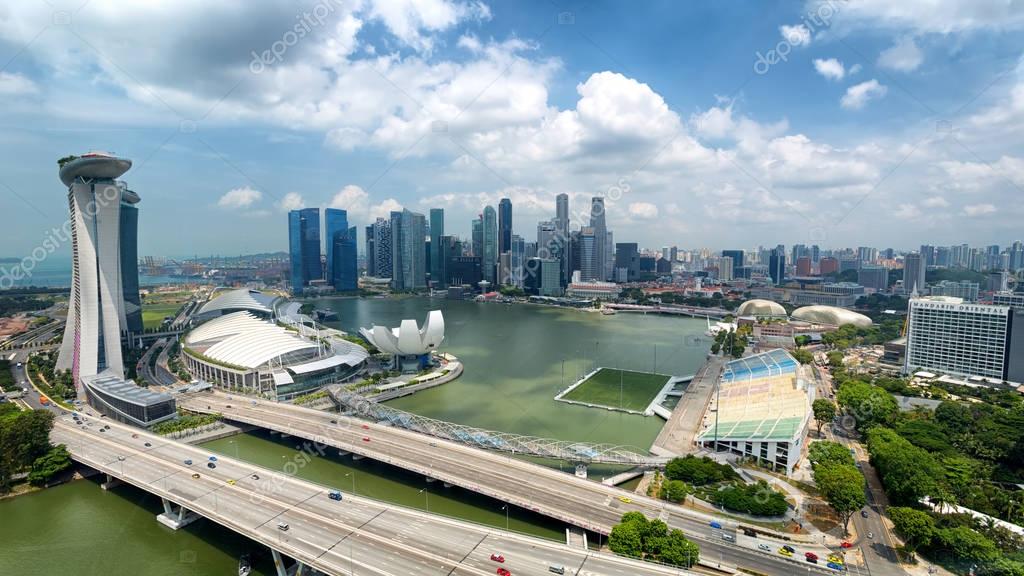 Singapore city skyline, Marina bay from top of Singapore flyer, Singapore. Names and logos blured.