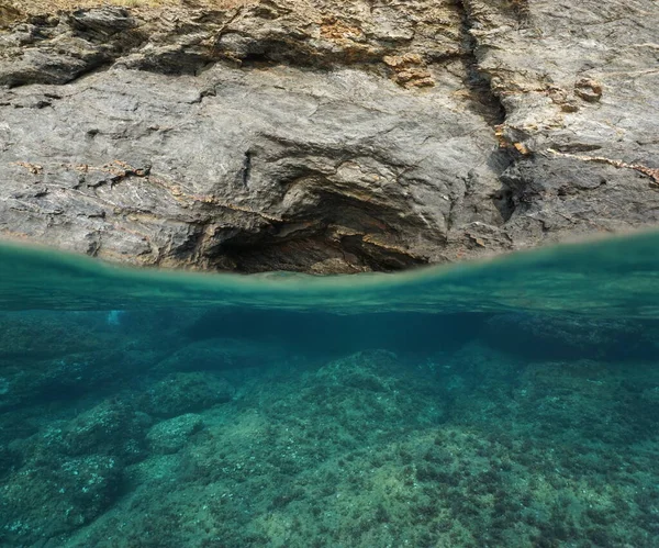 Over underwater rocky seashore cavern entrance