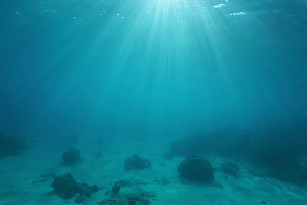 Ocean floor with sunlight through water surface