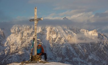 Lonely person portrait and Mountain Birnhorn Saalbach sunset summit cross clipart