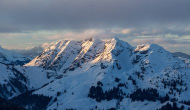 Dağ portresi Saalbach günbatımı bulutlar mükemmel mavi gökyüzü mor ışık karlı dağ manzarası