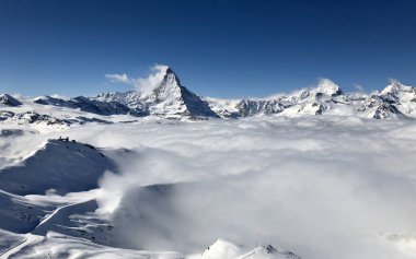 panorama view Zermatt Matterhorn gornergrat emerging from sea of clouds fog perfect sky clipart