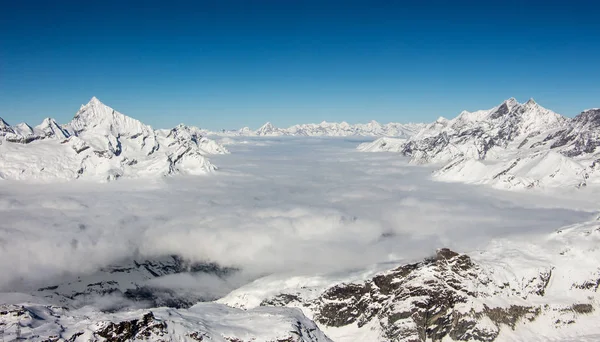 Sea of clouds Zermatt Matter valley and snowy mountains sunset view winter landscape Swiss Alps light — ストック写真