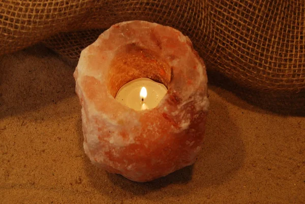 Himalayan Salt Lamp Candle Lit Natural Background Sand Burlap — Stock Photo, Image