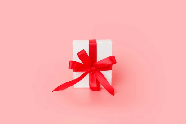 Happy Womens day template design. Decorative white gift box with red bow on pastel pink background. — 스톡 사진