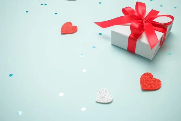 Holiday gift box with bow. Birthday surprise, Valentines day present with red satin tape close up. Copy space. — 스톡 사진