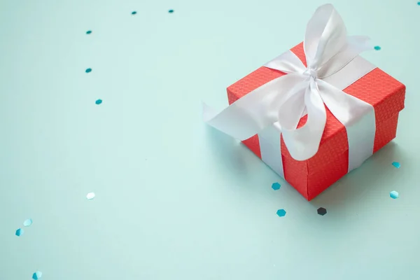 Holiday gift box with bow. Birthday surprise, Valentines day present with red satin tape close up. Copy space. — 스톡 사진