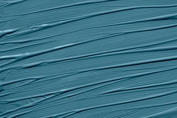 Blue stone trendy color of the year 2020. Abstract art background with brush strokes. Monochrome color texture.