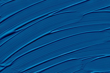 Classic blue trendy color of the year 2020. Abstract art background with brush strokes. Monochrome color texture.