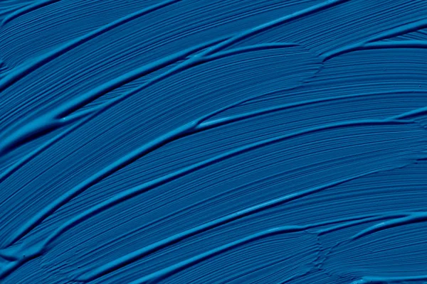 Classic blue trendy color of the year 2020. Abstract art background with brush strokes. Monochrome color texture.