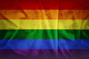 Fabric texture of gay rainbow flag background. A grunge background of the gay flag. clipart
